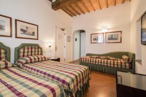 a hotel room with two beds in a room at Hotel Italia in Siena +59 photos