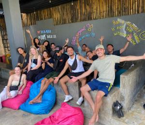 a group of people posing for a picture on bean bags at Stellar Capsules in Seminyak