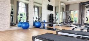 a gym with several treadmills and exercise machines at The one CozyHome in Nakhon Ratchasima