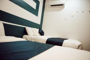 Postel nebo postele na pokoji v ubytování V Hotel Sri Gombak (Previously MyHome Hotel)