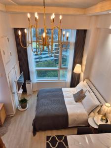 a bedroom with a large bed and a chandelier at Sunny House in Seoul