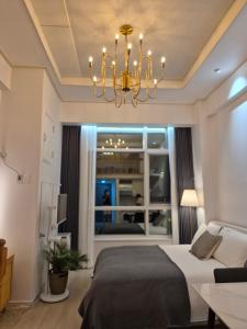 a bedroom with a bed and a chandelier at Sunny House in Seoul