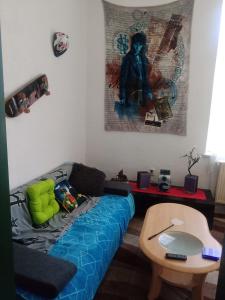 a living room with a blue couch and a table at Privatzimmer ohne Komfort im historischen Bahnhof Lalendorf in Lalendorf