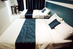 Postel nebo postele na pokoji v ubytování V Hotel Sri Gombak (Previously MyHome Hotel)