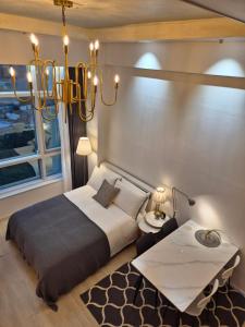 a bedroom with a large bed and a chandelier at Sunny House in Seoul +63 photos