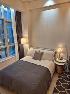 a bedroom with a large bed and a window at Sunny House in Seoul