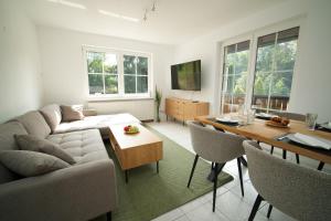 a living room with a couch and a table at Gemütliches Apartment in Velden in Velden am Wörthersee