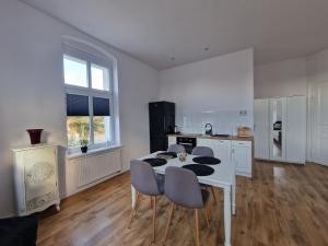 a kitchen with a table and chairs in a room at Apartamenty Zakonne "Apartament Wielkiego Mistrza" in Malbork +10 photos