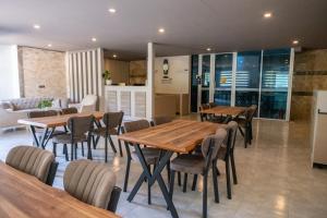 a dining room with wooden tables and chairs at Konyaalti Suite Hotel in Antalya