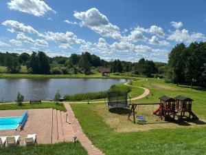 a park with a pool and a playground next to a lake at DOLINA NAD MOŁSTOWĄ in Starnin
