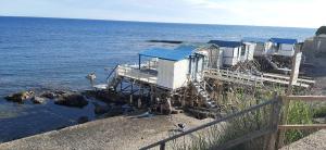a building on the shore of the ocean at La Casa al mare in Santa Marinella +5 photos