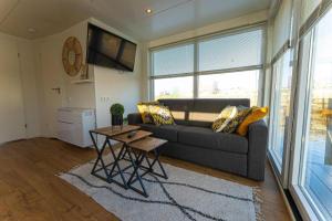 a living room with a couch and a table at Houseboat Tomio NS001 near Amsterdam in Monnickendam