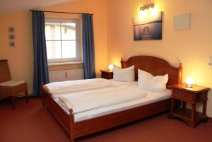 a bedroom with a large bed and a window at Villa Strandkorb in Graal-Müritz