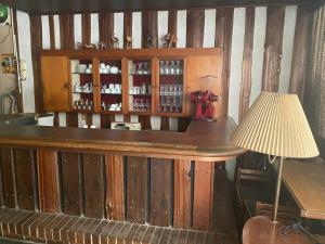a bar with a table and a lamp at McArthur Heights Hotel in Miura