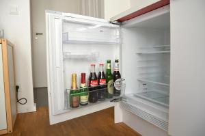 an open refrigerator filled with bottles of alcohol at Ferienwohnung an der historischen Stadtmauer in Rostock