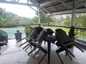 a group of chairs sitting around a table on a balcony at Davao City-Marilog Peak Cafe- Traveler's Staycation in Davao City +8 photos