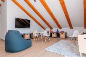 a living room with a blue couch and chairs at Villa Silvana in Bilice