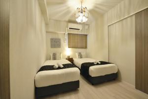 Ένα ή περισσότερα κρεβάτια σε δωμάτιο στο Branchera Naha Akebono Premist R65