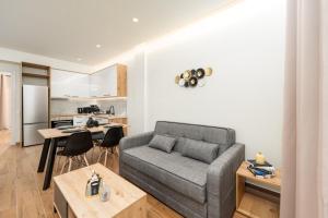 a living room with a couch and a kitchen at Vitsas House in Athens