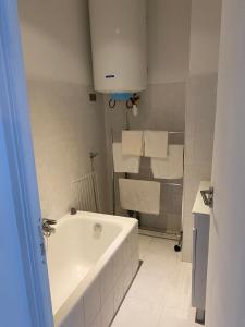 a bathroom with a white tub and white towels at Appartement Flores in Nice +8 photos