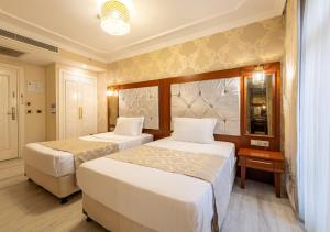 Postel nebo postele na pokoji v ubytování Myy Boutique Hotel
