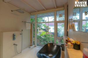 a bathroom with a black sink and a shower at The Glasscape by StayVista - Hillside getaway with Pool and Indoor games in Nashik +19 photos