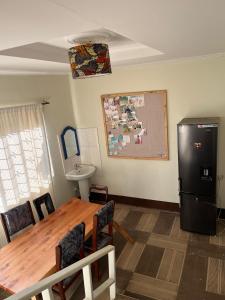 cocina con mesa y nevera negra en Safari Junction Backpackers hostel, en Iringa