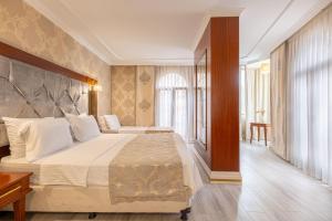 Postel nebo postele na pokoji v ubytování Myy Boutique Hotel