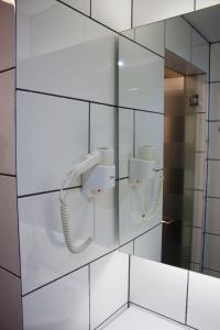 a phone on a wall in a bathroom at Lazdana Hotel Kuala Lumpur in Kuala Lumpur