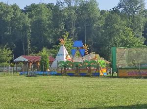 a playground in a park with a play structure at Chez Suzanne Maison à la campagne 2-8pers 4 chambres in Longeville-sur-la-Laines