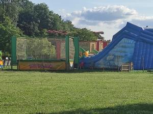 a playground with a blue slide in a field at Chez CHARLETTE in Les Malots