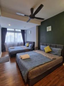 a bedroom with two beds and a ceiling fan at Fahrenheit 88 Suites Bukit Bintang by Roseline 2R in Kuala Lumpur