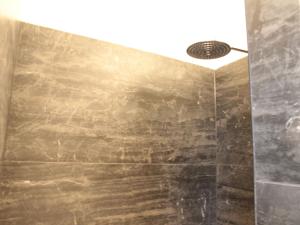 a shower with a stone wall and a ceiling at Villa in Zealand near Dutch Flanders Coast in Zuidzande +28 photos