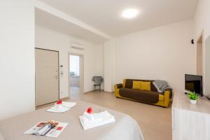 a living room with a couch and a table at Suite Ondina Viareggio Apartments in Viareggio