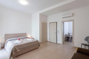 a bedroom with a bed and a living room at Suite Ondina Viareggio Apartments in Viareggio
