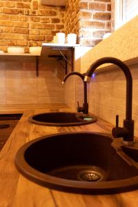 a sink in a kitchen with a wooden counter top at Hostel ViktoryHome in Kryvyi Rih +46 photos
