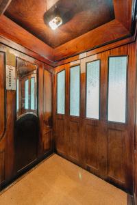 an empty room with wood paneling and windows at Old Town Square Apartments Cluj in Cluj-Napoca