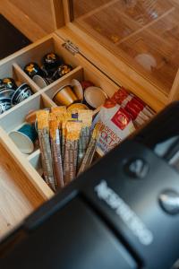 a drawer filled with different types of food and drinks at Old Town Square Apartments Cluj in Cluj-Napoca +13 photos
