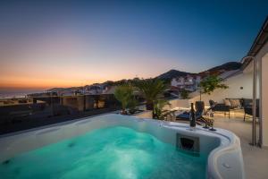 a hot tub on a balcony with a view of the ocean at Luxury Penthouse Hvar with Jacuzzi & Sea View in Hvar