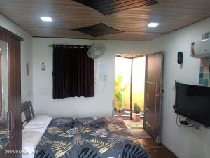 a bedroom with a bed and a flat screen tv at Western Valley Cottages , Panchagani in Panchgani