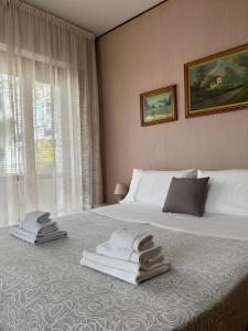 a hotel room with a bed with towels on it at Elios Apartment in Tropea