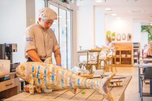 a chef preparing a large fish on a table at Spirit Hotel Benalmadena Beach in Benalmádena