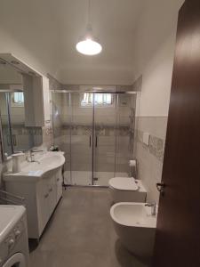 a bathroom with two sinks and a shower and two toilets at B&B Villa VITTORIO in Galatone +79 photos