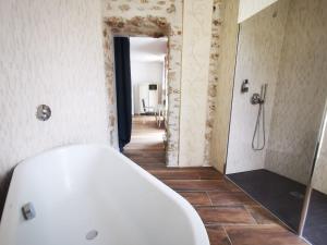 a bathroom with a white tub and a shower at Château de la PLUMASSERIE in Fontenay-Trésigny +34 photos