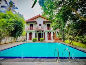 a house with a swimming pool in front of it at The Kandy Mount Layathraa in Kundasale