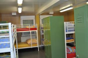 a room with several bunk beds in a room at Gästedorf Waldheimat in Langenwang