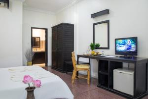 a bedroom with a desk with a computer on it at The Oasis Harbor in Siem Reap