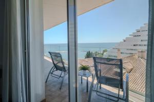 a balcony with two chairs and a table at Spirit Hotel Benalmadena Beach in Benalmádena