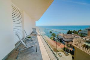 a balcony with chairs and a view of the ocean at Spirit Hotel Benalmadena Beach in Benalmádena