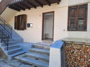 a house with stairs and a door and a window at Casa Dolomiti in Mezzano